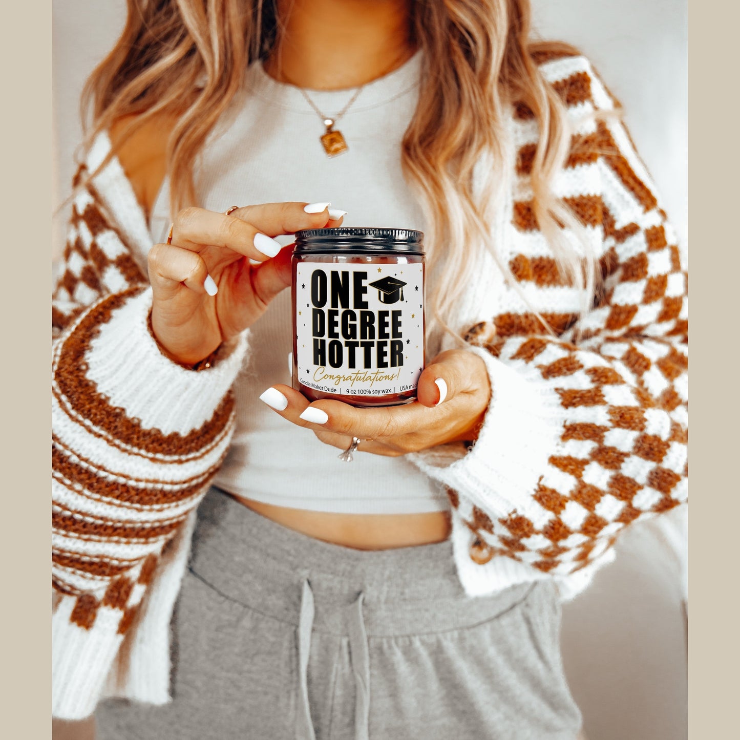 a woman holding a can of beer in her hands