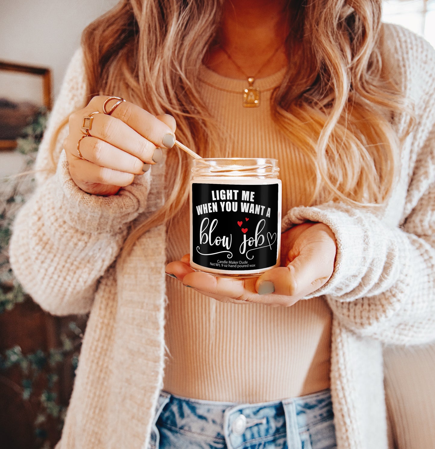 a woman is holding a jar of candles
