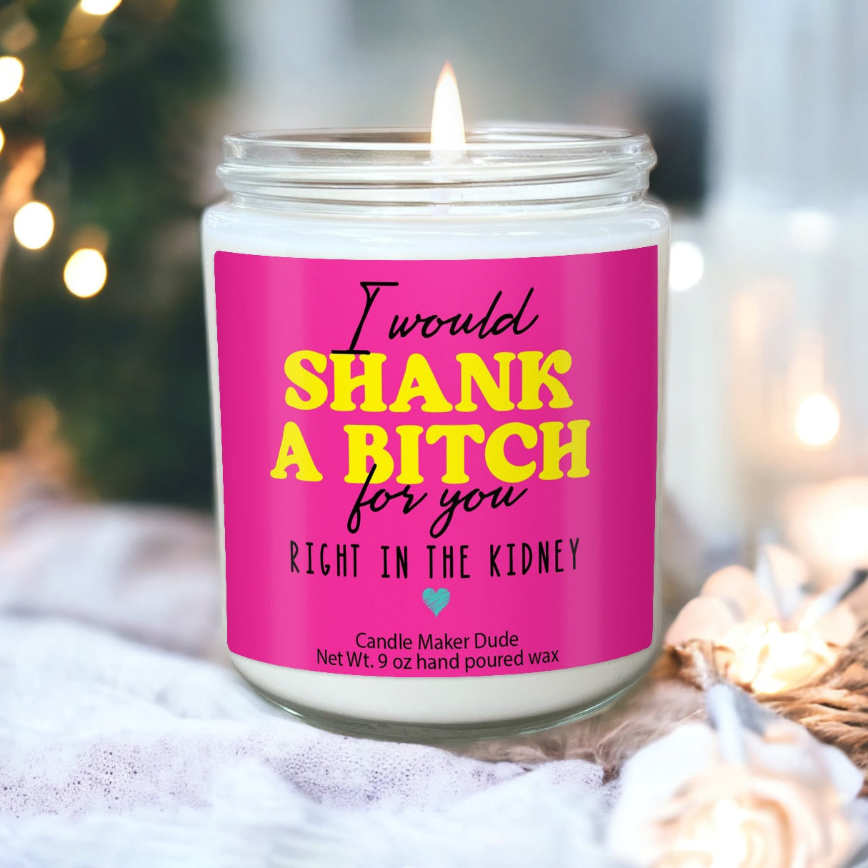 a pink candle sitting on top of a table