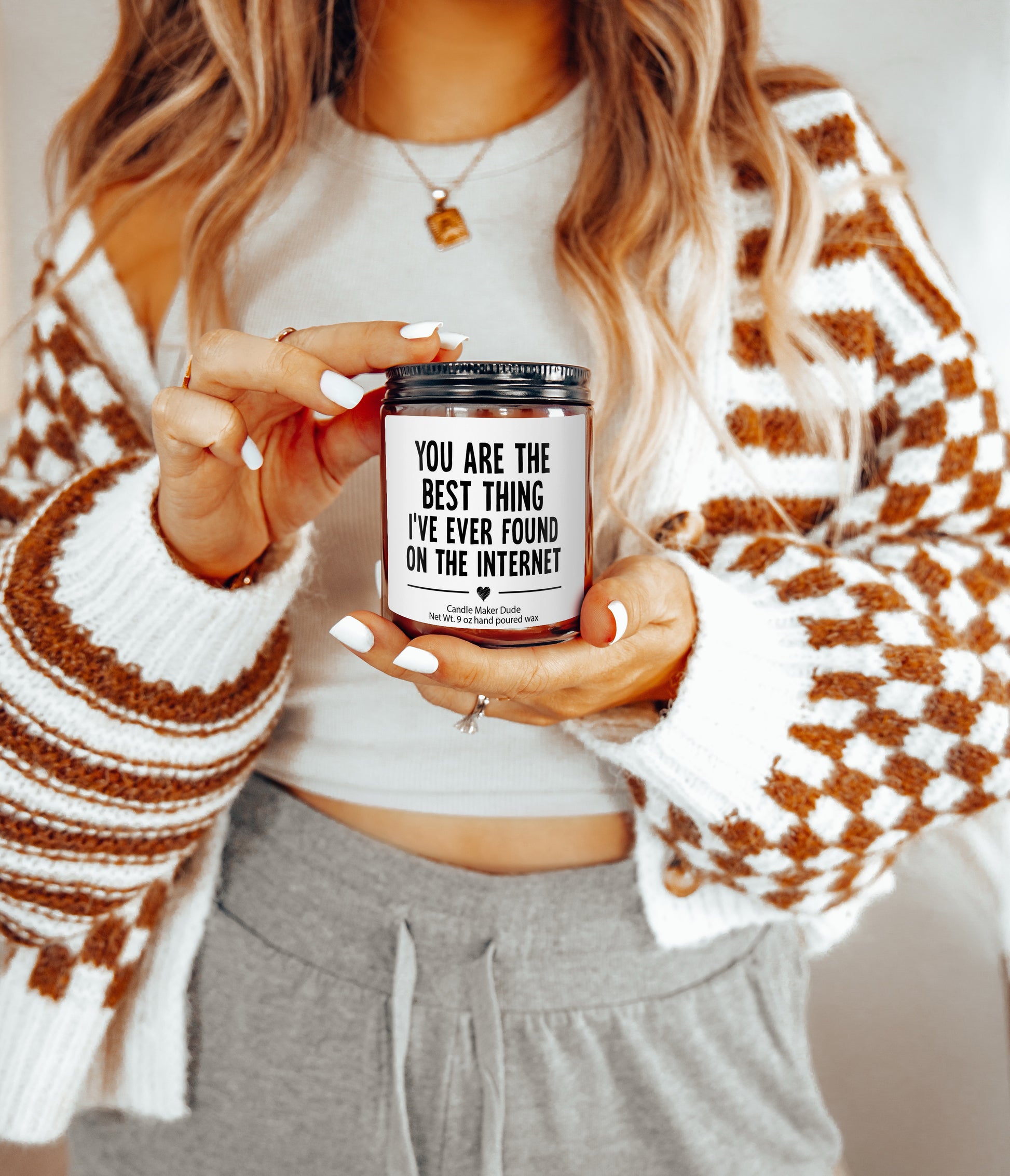 a woman holding a jar of coffee in her hands