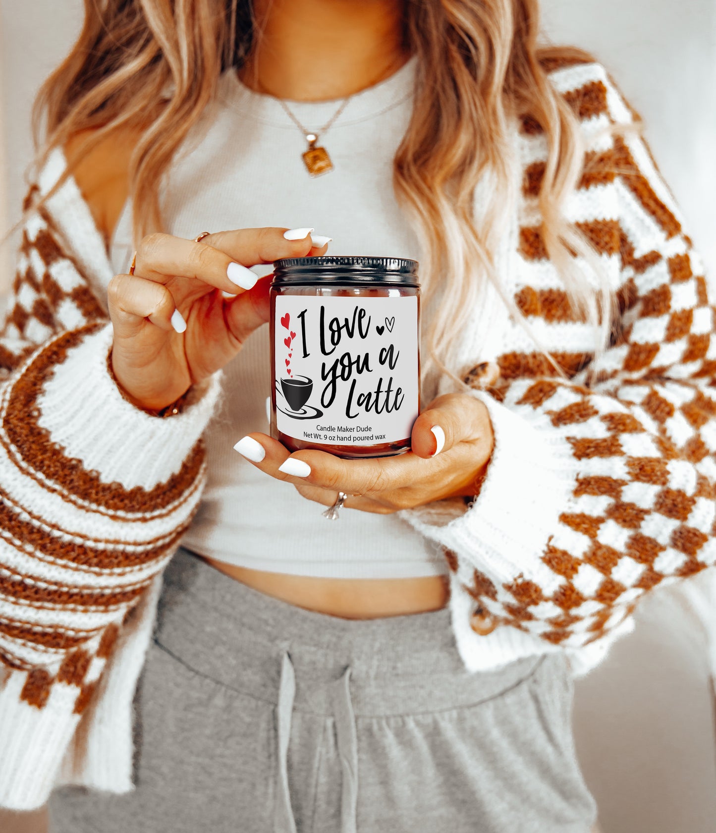 a woman holding a can of coffee in her hands