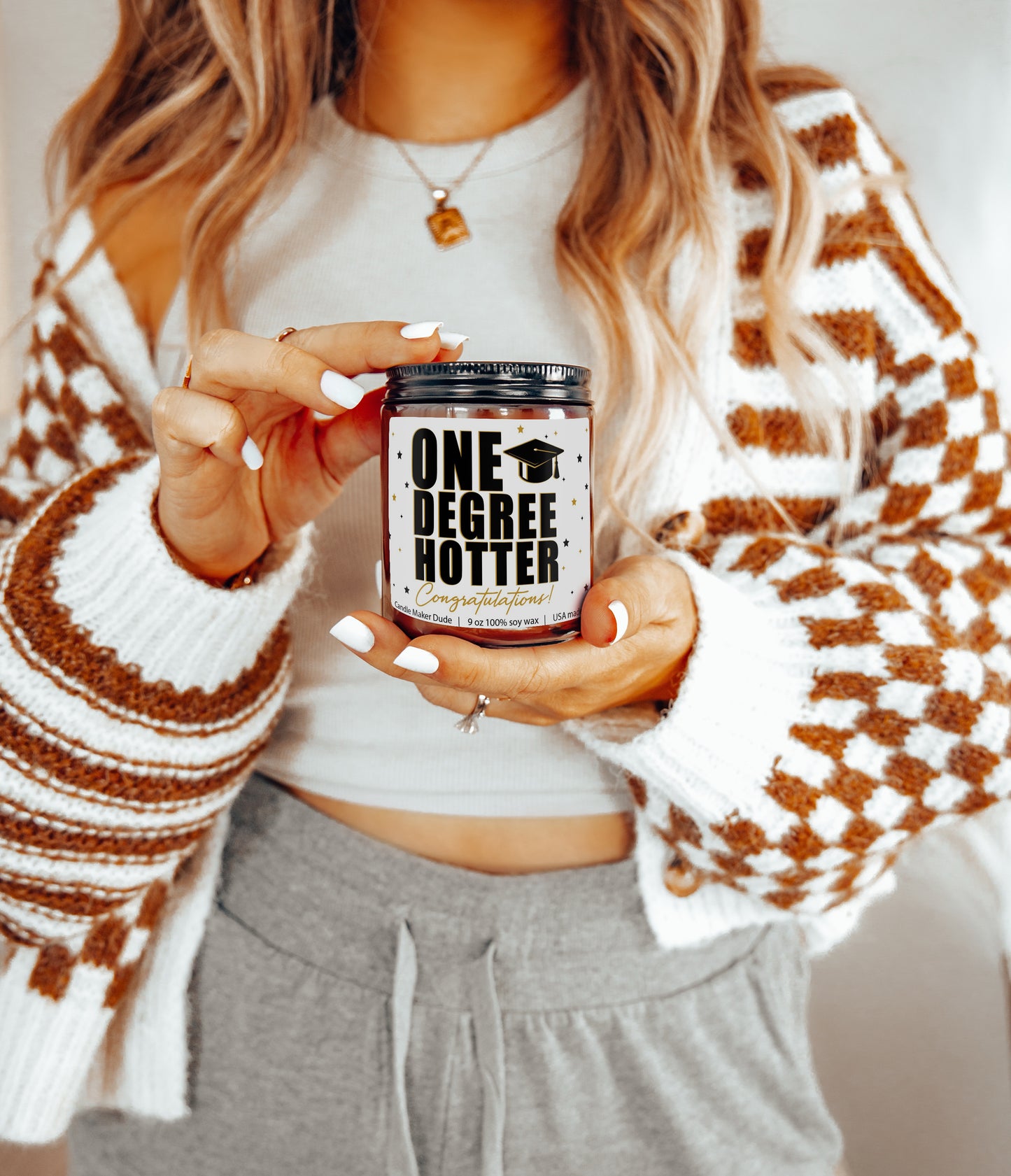 a woman holding a can of beer in her hands