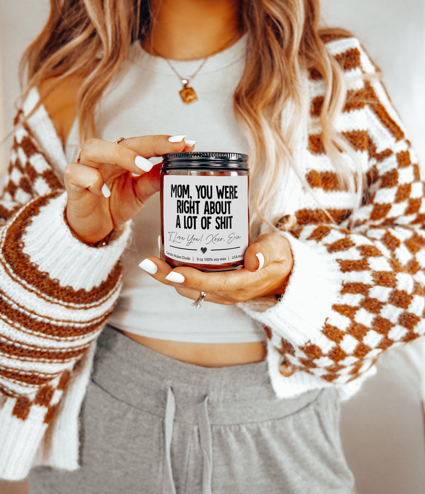 a woman holding a jar of coffee in her hands